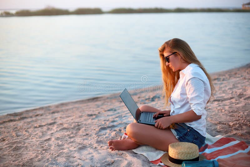 Authentic woman working with laptop on sea shore. Freelancer girl telecommuting with team on project on tropical island royalty free stock photo Authentic woman working with laptop on sea shore. Freelancer girl telecommuting with team on project on tropical island royalty free stock photo