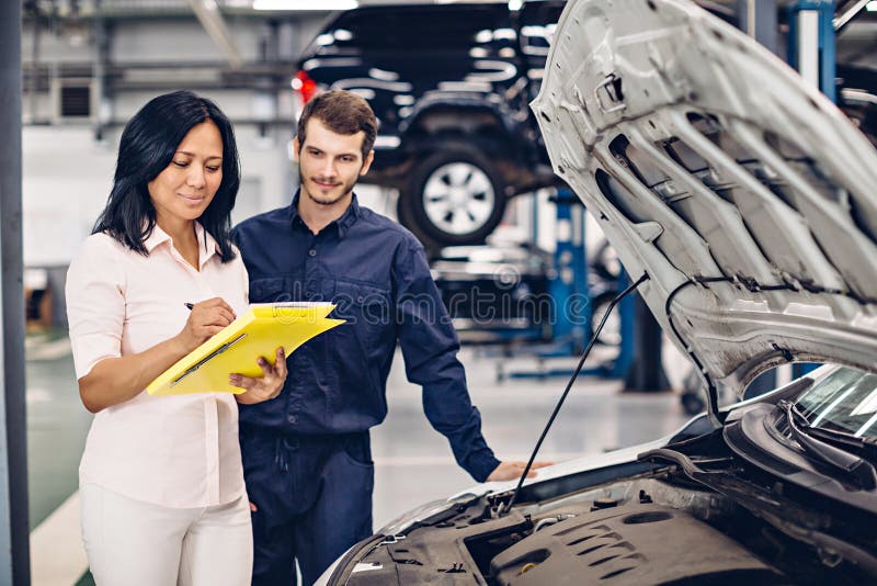 Auto Car Repair Service Center. the Mechanic Communicates with the