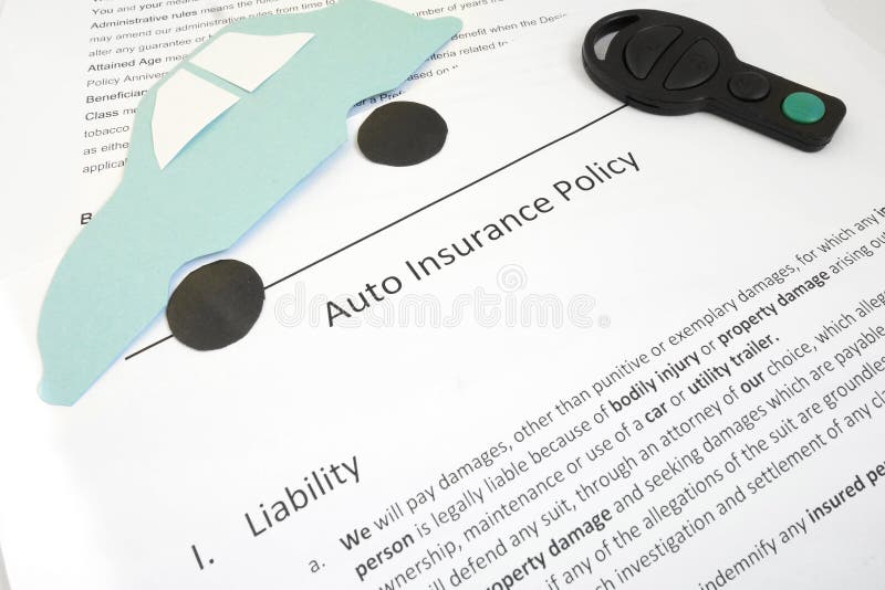 Auto insurance policy and key with paper car. Auto insurance policy and key with paper car