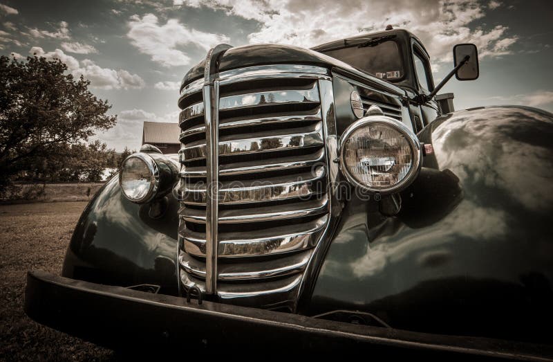 Front grill and headlights of vintage automobile with filter applied. Front grill and headlights of vintage automobile with filter applied.