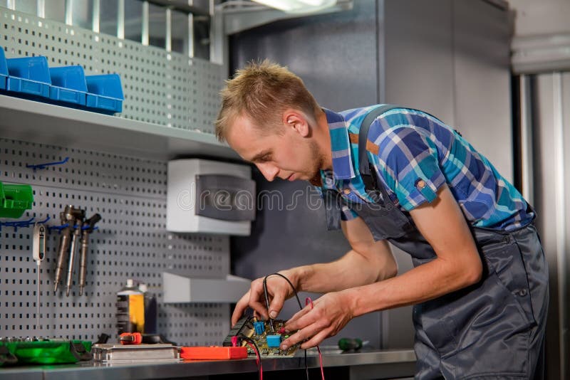 Real Auto Electrical Worker in Garage. Stock Photo Image of interior