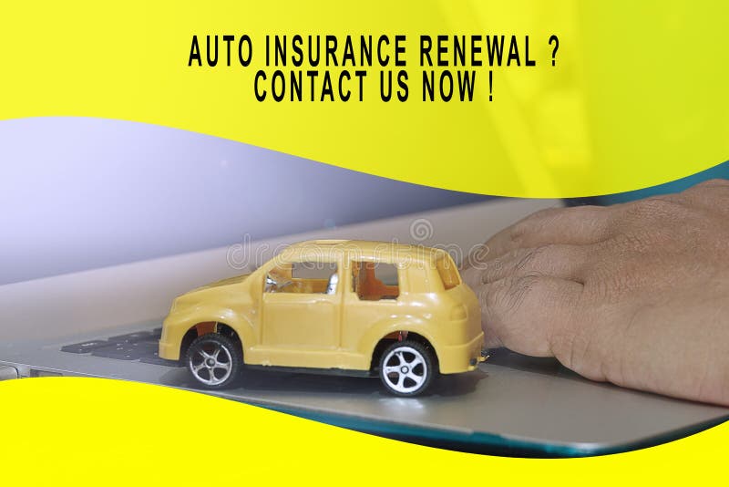 Auto Insurance Conceptual with Small Yellow Car Model on a Laptop Stock