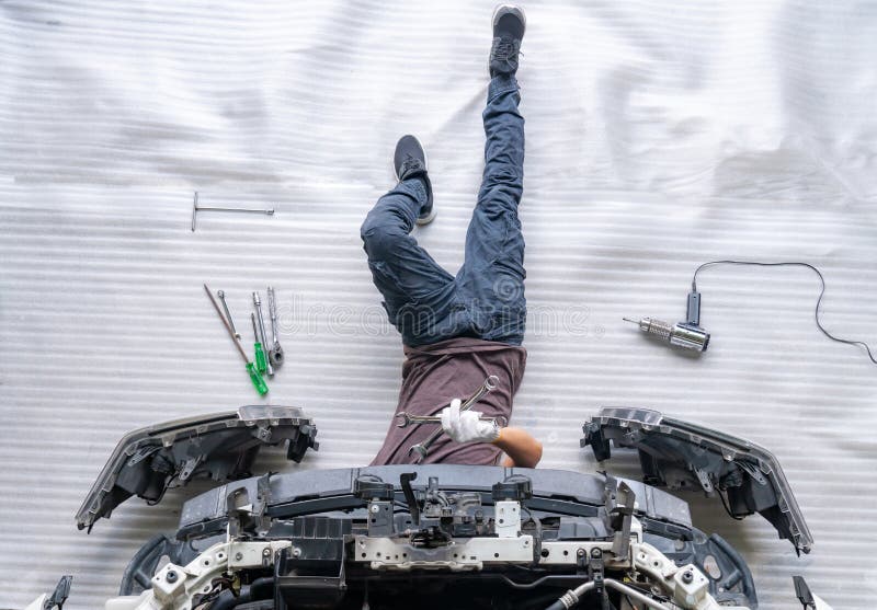 Auto mechanic is assembling car parts stock photos Auto mechanic is assembling car parts stock photos