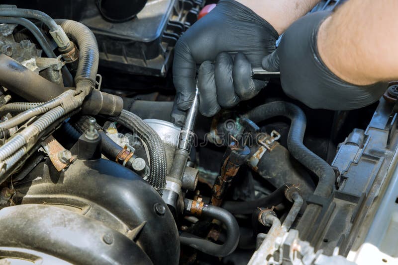Auto Mechanic Installing a Throttle Body on the Engine Stock Photo