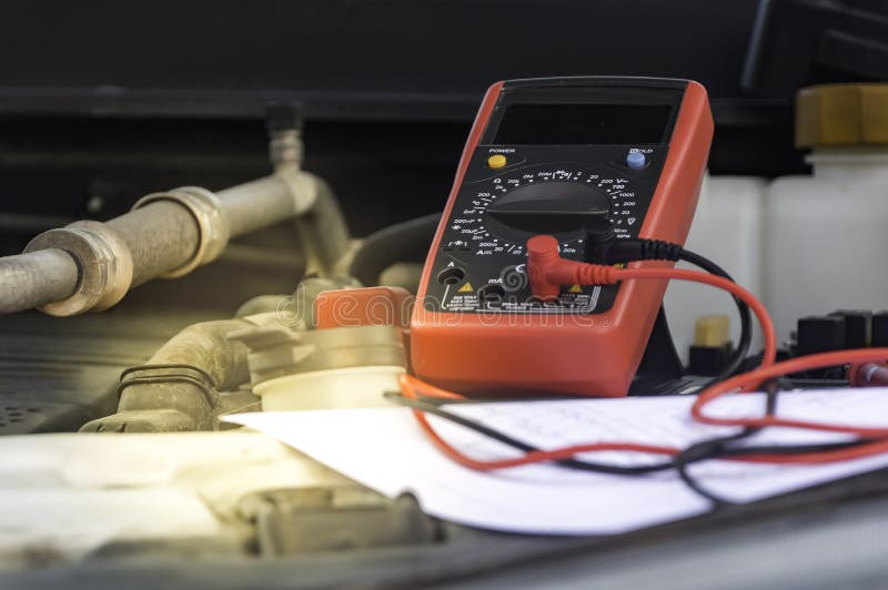 Auto Mechanic Uses a Multimeter Voltmeter. Stock Image Image of