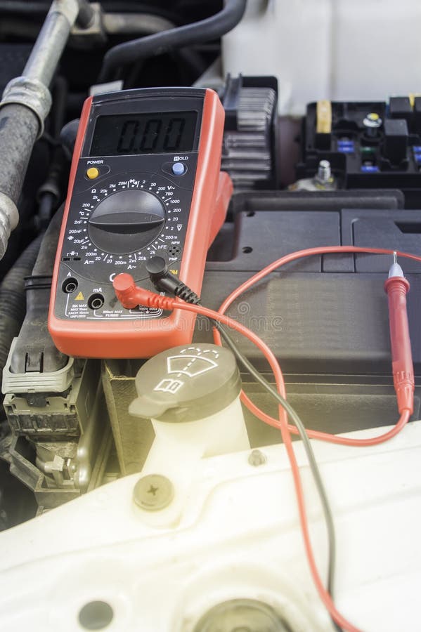 Auto Mechanic Uses a Multimeter Voltmeter. Stock Photo Image of auto