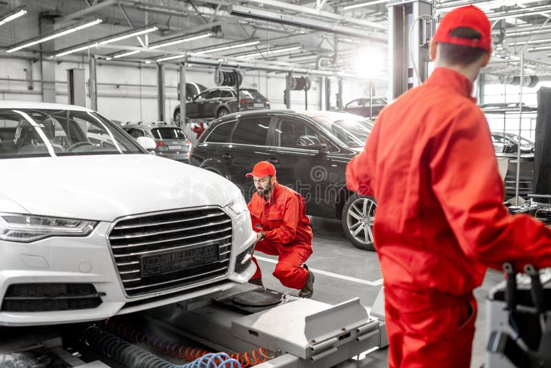 Auto Mechanics Serving Luxury Car at the Car Service Stock Photo