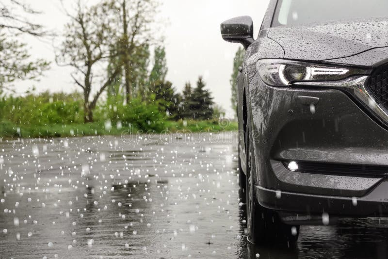 Car parked outdoors on rainy day with hail. Car parked outdoors on rainy day with hail