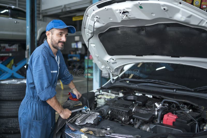 Auto services and Small business concepts. Auto mechanic hands using wrench to repair a car engine