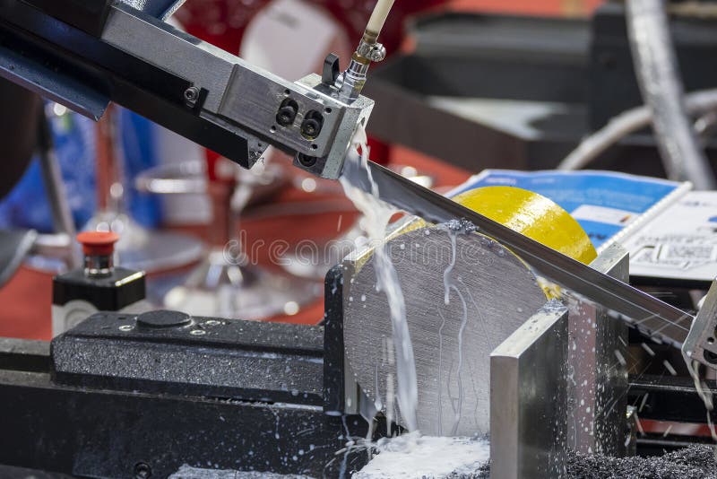 The Automatic Band Saw Machine Cutting the Metal Bar with Water Base Coolant Method Stock Image