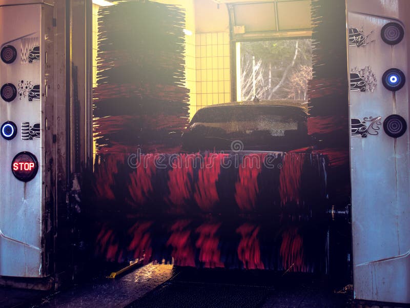 Automatic Brush Car Wash in Process, Red and Black Brushes Stock Photo