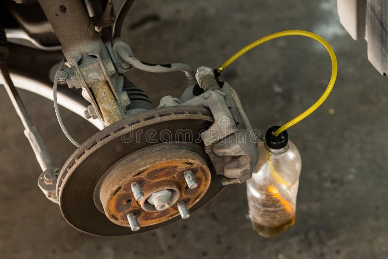Automatic Change of Brake Fluid in a Car Service. Stock Photo Image
