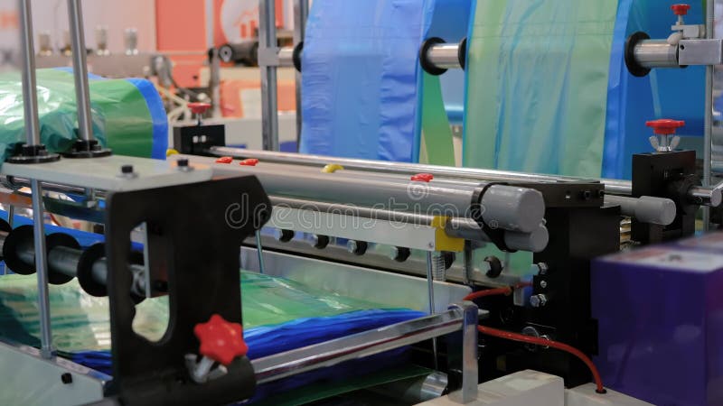 Automatic plastic bag making, cutting, sealing machine during work at exhibition stock video footage