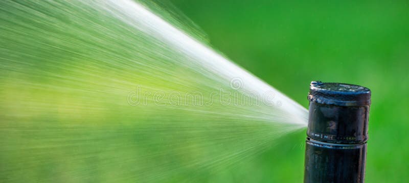 Automatic Sprinkler System Watering the Lawn Close Up Stock Image