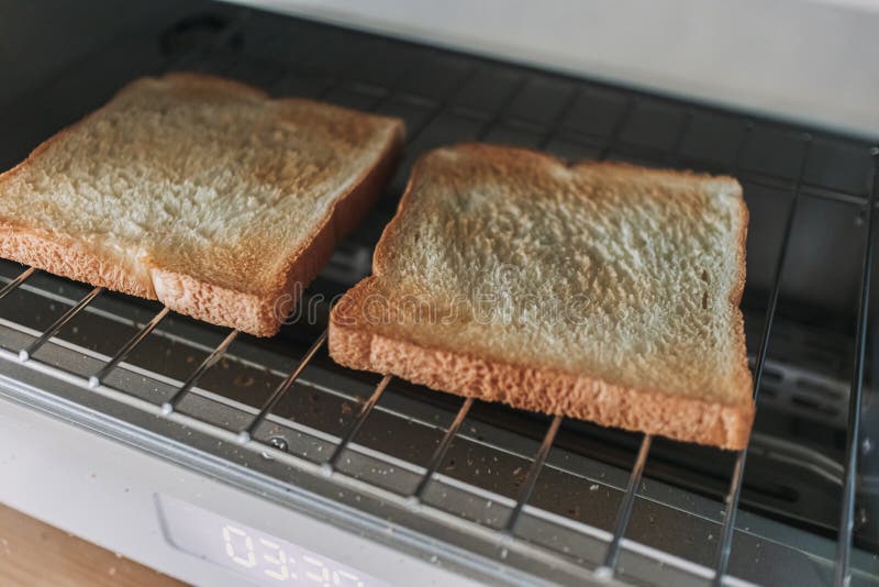 White Breads Toaster Steamed Oven with Breads Inside in Kitchen. Stock
