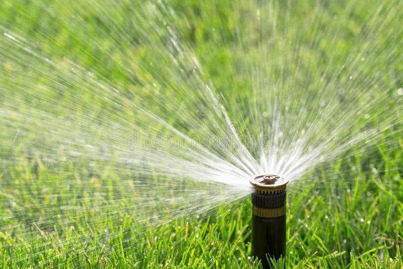 Automatic sprinkler watering fresh lawn. Automatic sprinkler watering fresh lawn