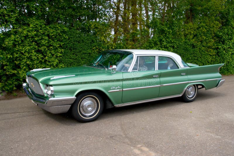 ROSMALEN, THE NETHERLANDS - MAY 16: 1960 Chrysler Winsor Golden Line classic car on the Rock Around the Jukebox Open Air event on May 16, 2010 in Autotron Rosmalen. ROSMALEN, THE NETHERLANDS - MAY 16: 1960 Chrysler Winsor Golden Line classic car on the Rock Around the Jukebox Open Air event on May 16, 2010 in Autotron Rosmalen.