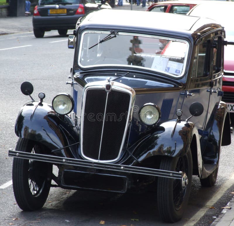 A vintage car parked on the road. A vintage car parked on the road.