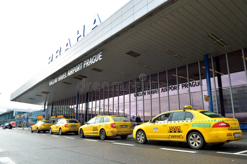 Prague international airport of the Czech Republic. The principal entry in airport terminals with yellow taxi cars in front of it. Prague international airport of the Czech Republic. The principal entry in airport terminals with yellow taxi cars in front of it.