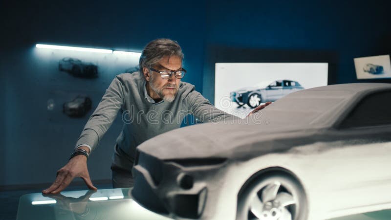 Automotive Engineer Touches the Model of the Prototype Car To Make
