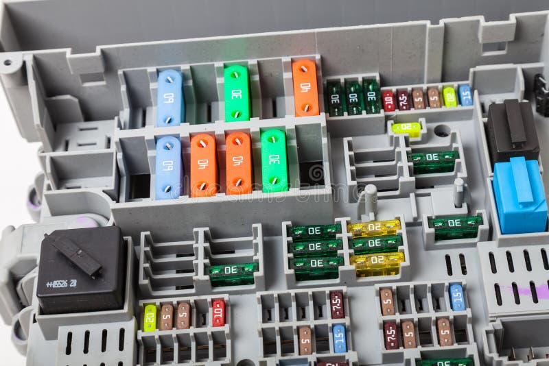 Automotive Fuses on a White Panel with Holders and Multicolored
