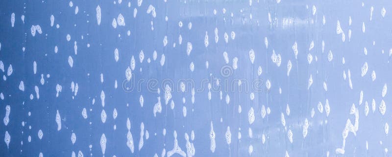 car cleaning and washing with foam soap on the blue car background. car cleaning and washing with foam soap on the blue car background.