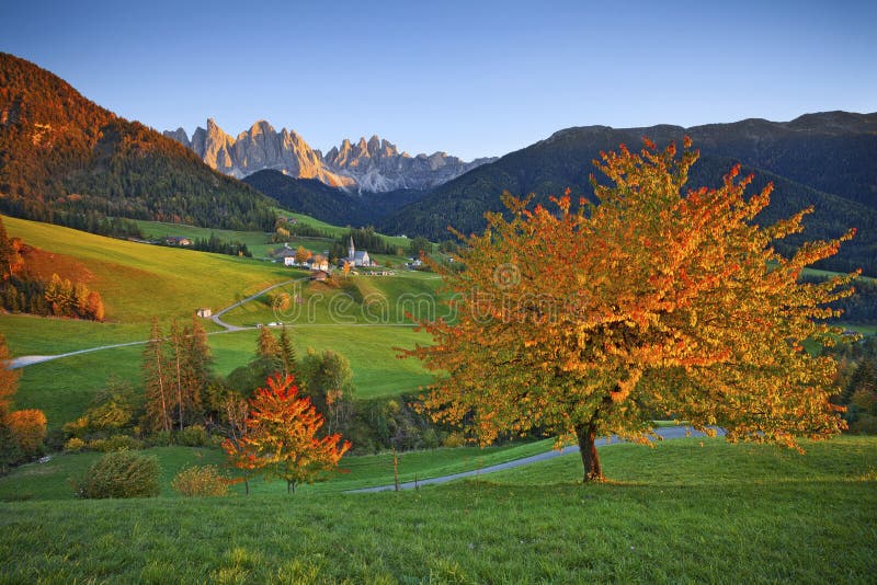 Beautiful St. Magdalena village in a gorgeous Funes Valley located in Italian Alps during autumn sunset. Beautiful St. Magdalena village in a gorgeous Funes Valley located in Italian Alps during autumn sunset.