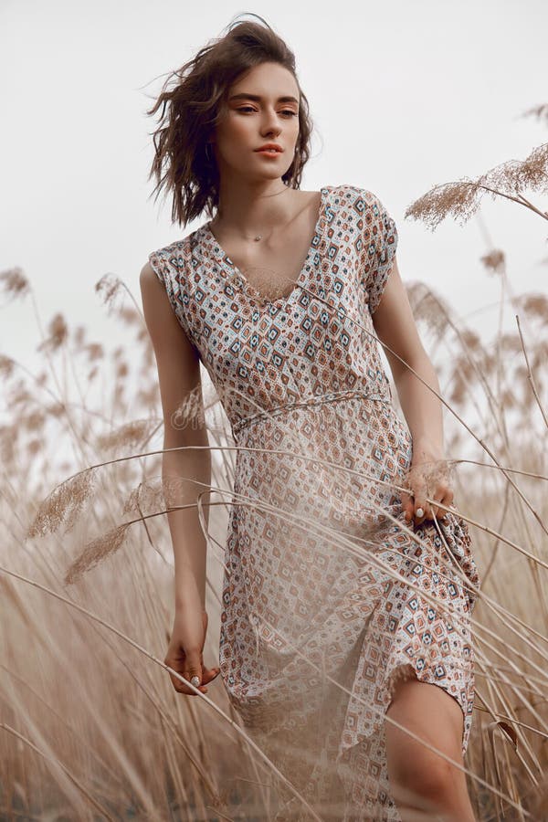 Autumn beauty portrait of a beautiful girl in a field in the grass rays of the sunset. Lifestyle woman with natural makeup on royalty free stock photo Autumn beauty portrait of a beautiful girl in a field in the grass rays of the sunset. Lifestyle woman with natural makeup on royalty free stock photo