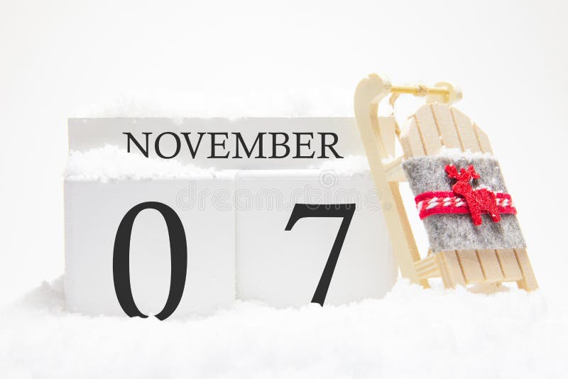Autumn calendar made of wooden cubes with the date of November 7, the concept of the first snow and future holidays. Close-up stock photography Autumn calendar made of wooden cubes with the date of November 7, the concept of the first snow and future holidays. Close-up stock photography