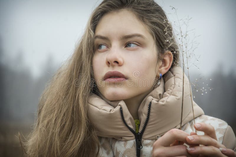 In Autumn, on a Cold Frosty Morning, a Girl in the Grass with Dew Drops ...