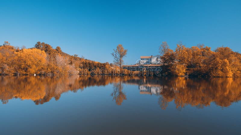 Autumn Colors Forest Woods Yellow Orange Reflecting on Blue Water Lake Landscape Natural Clear Weather Beautiful