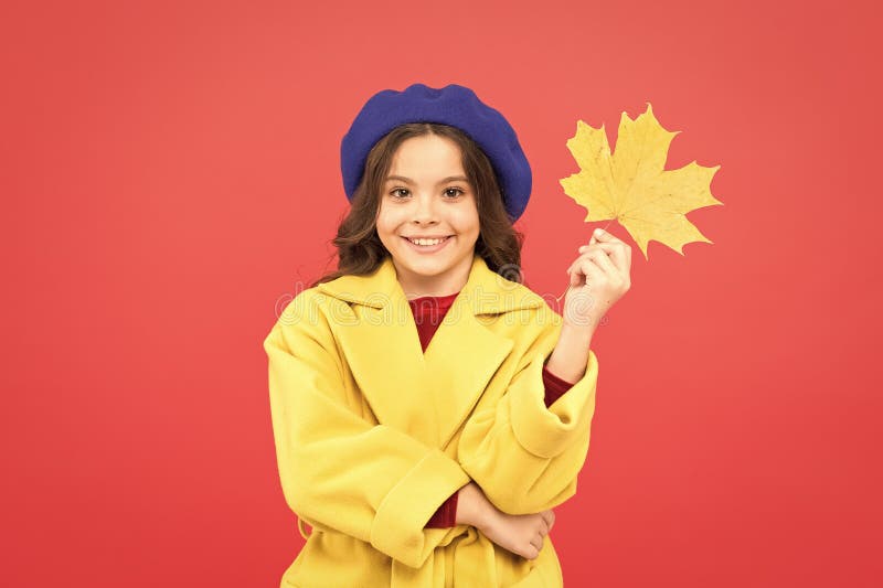 Autumn fashion. happy little girl with maple leaf. autumn kid fashion. parisian girl child in french beret and yellow stock images
