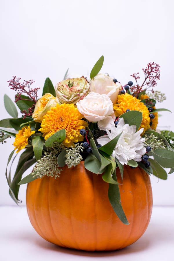 Autumn Floral Bouquet in a Pumpkin Vase on a Light Background, a ...