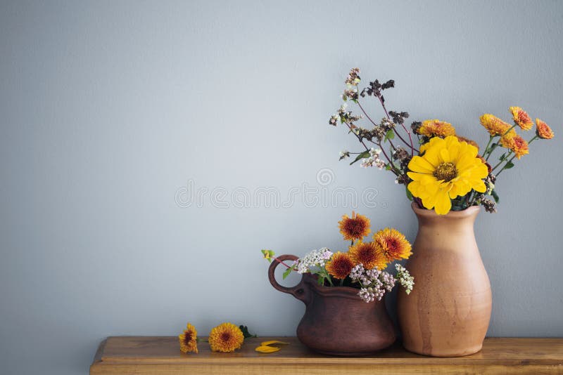 Flowers in Rustic Ceramic Vase on Background Gray Wall Stock Image