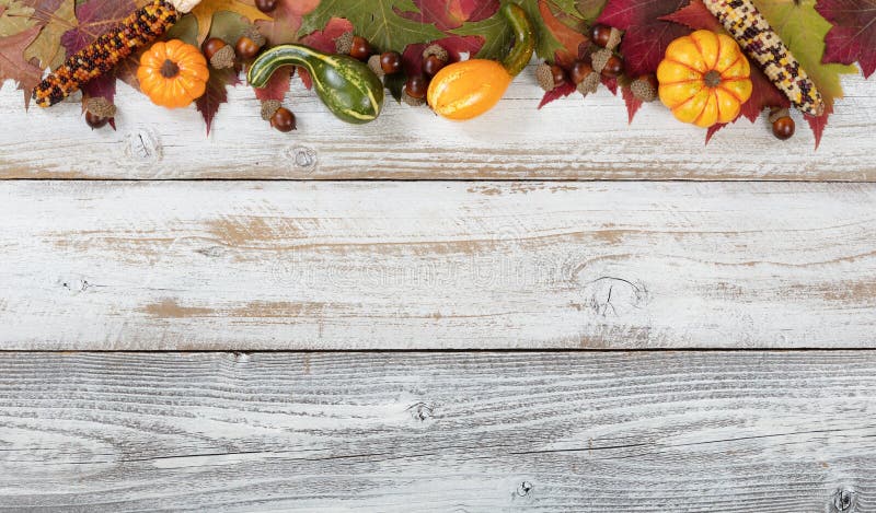 Top border of Autumn foliage with other fall decorations on whit