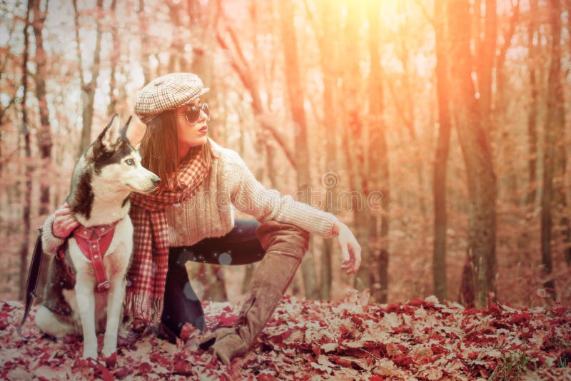 Autumn Girl walking with husky dog autumn forest. Unconditional love. Pedigree dog concept. Girl enjoy walk with husky royalty free stock images Autumn Girl walking with husky dog autumn forest. Unconditional love. Pedigree dog concept. Girl enjoy walk with husky royalty free stock images
