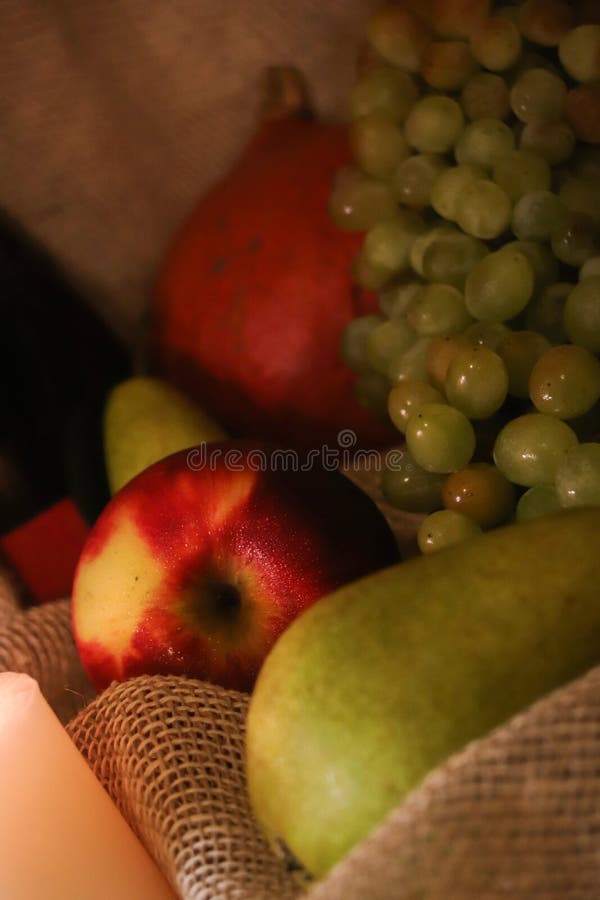 Autumn harvest still life. Fresh fruits: apple, pears, grapes and pumpkin on a sackcloth. Happy thanksgiving royalty free stock photography Autumn harvest still life. Fresh fruits: apple, pears, grapes and pumpkin on a sackcloth. Happy thanksgiving royalty free stock photography