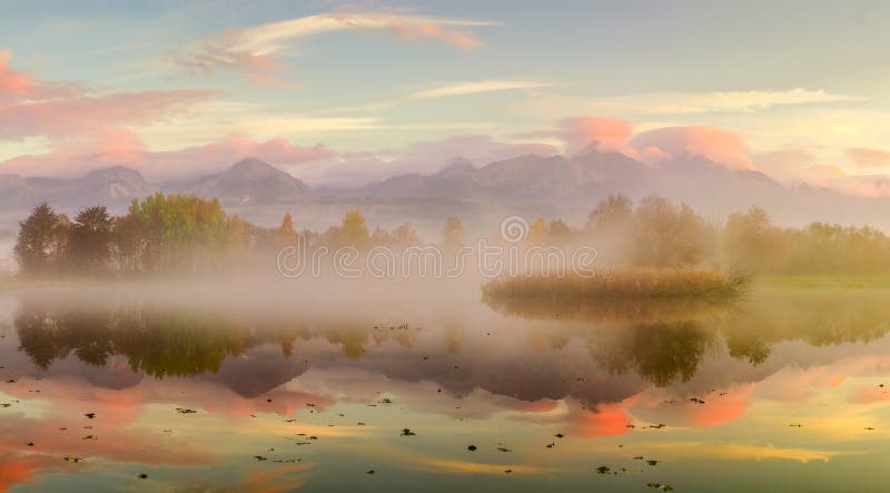 Autumn landscape and foggy lake