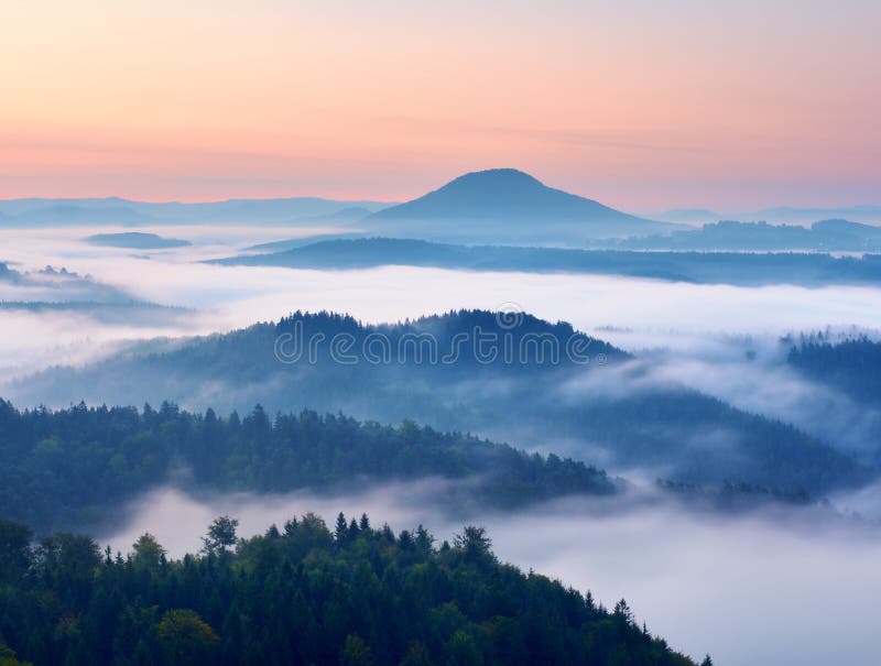 Autumn landscape. Gentle mist, magnificent autumn creamy fog above forests. High hill increased from fog. Autumn landscape. Gentle mist in hilly land stock image Autumn landscape. Gentle mist, magnificent autumn creamy fog above forests. High hill increased from fog. Autumn landscape. Gentle mist in hilly land stock image