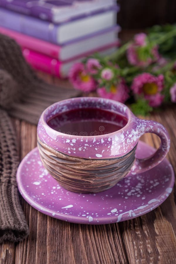 Autumn mood. Fruit tea, books and flowers asters on a wooden background