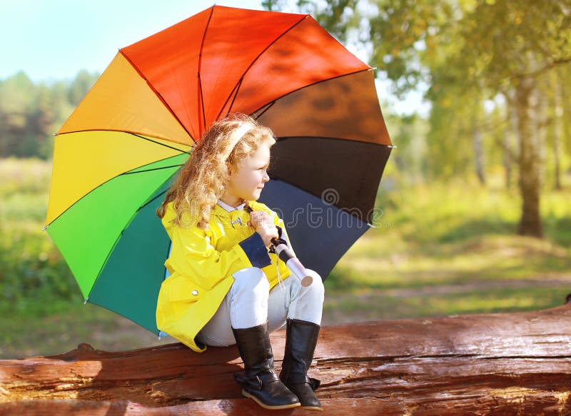 Autumn photo, little child with colorful umbrella