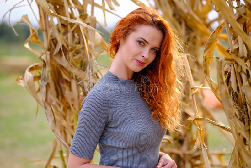 Autumn portrait of a beautiful woman with pumpkins