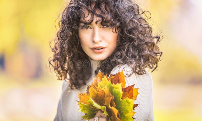 Autumn portrait of young woman with curly hair and bouquet of maple leaves royalty free stock photos Autumn portrait of young woman with curly hair and bouquet of maple leaves royalty free stock photos