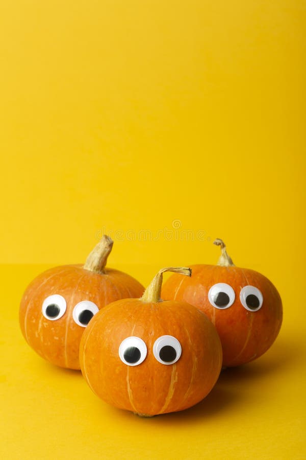 Autumn pumpkins on a yellow background. Concept for Autumn, Harvest, Halloween and Thanksgiving. Pumpkin Dishes