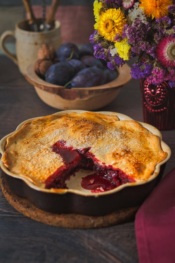 Autumn red fruit pie in rustic decor. Home-baked autumn red fruit pie, in a brown ceramic pie plate, ready to serve stock images Autumn red fruit pie in rustic decor. Home-baked autumn red fruit pie, in a brown ceramic pie plate, ready to serve stock images