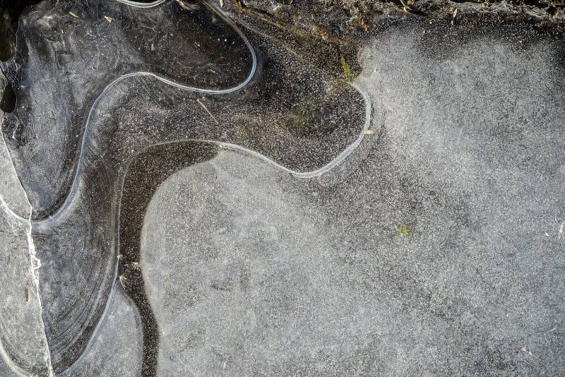 Autumn scene lines ice in a frozen pond