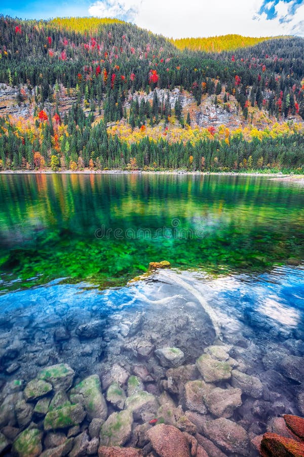 autumn scenery with Dachstein mountain summit reflecting in crystal clear Gosausee mountain lake
