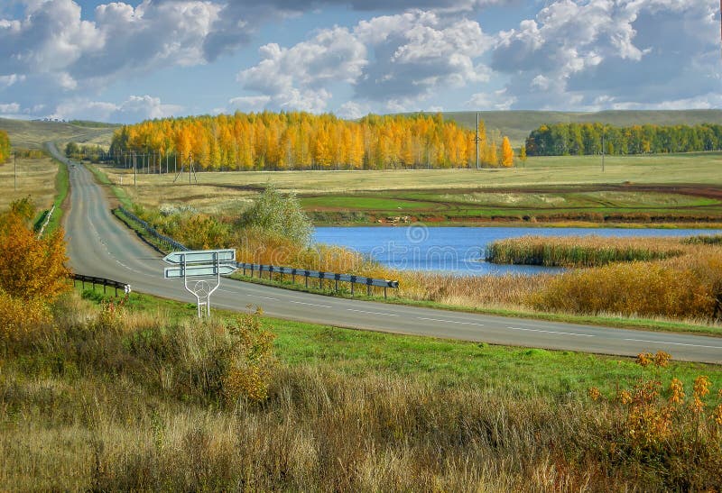 Autumn yellow birch forests and lake of Russia scenic landscape road in the valley stock image Autumn yellow birch forests and lake of Russia scenic landscape road in the valley stock image