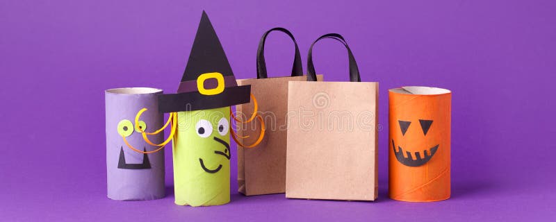 Autumn season Halloween holiday sale concept - toy from toilet roll tube recycle idea and paper craft shopping bag on purple back