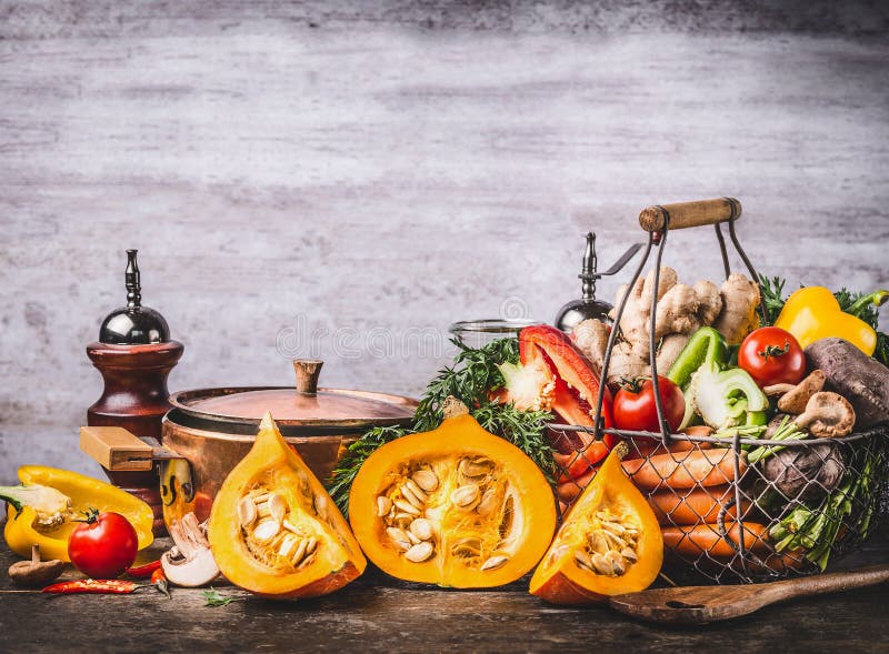 Autumn seasonal food still life with pumpkin, mushrooms, various organic harvest vegetables and cooking pot on rustic kitchen tabl royalty free stock photography Autumn seasonal food still life with pumpkin, mushrooms, various organic harvest vegetables and cooking pot on rustic kitchen tabl royalty free stock photography